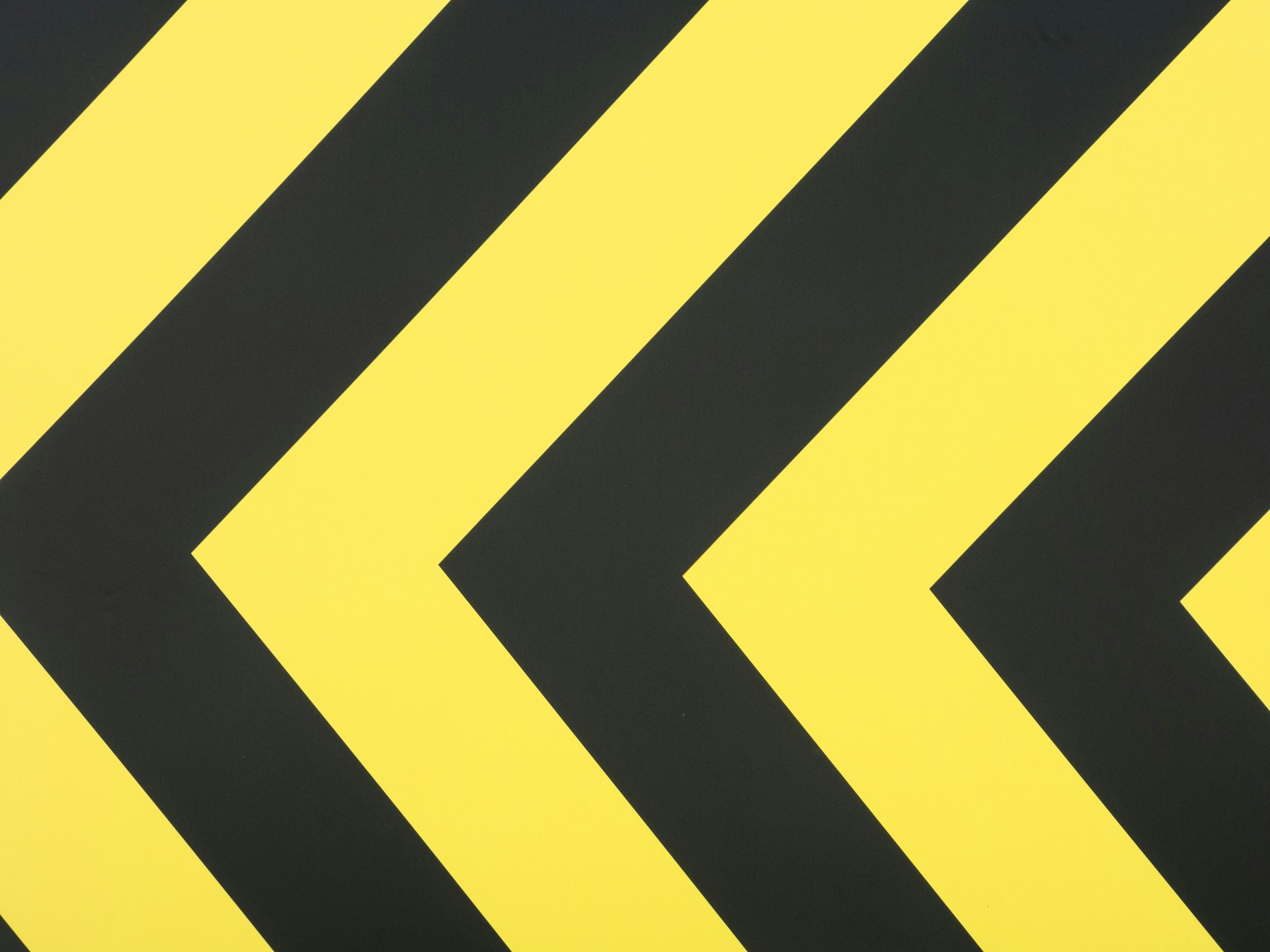 a close up of a yellow and black arrow sign